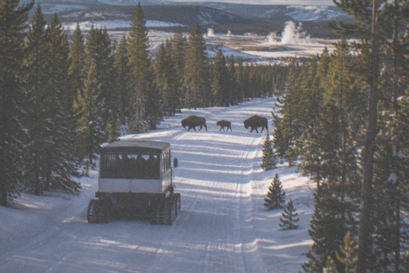 Snowcoach and winter wildlife-tour vehicle in Grand Teton National Park with snow-covered peaks
